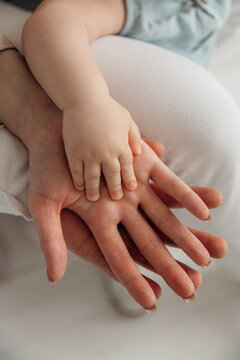 Joining hands of child, mother and father. Top view