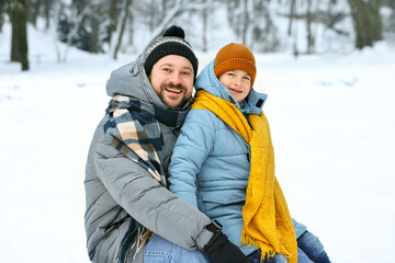 Fototapeta premium Father and his son spending time together outdoors on winter day