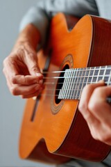 Fototapeta premium Close-up of hands playing an acoustic guitar