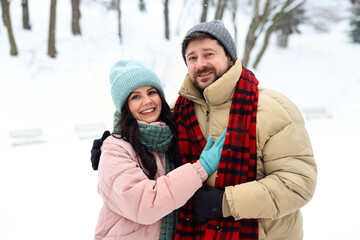 Fototapeta premium Portrait of happy couple outdoors on winter day