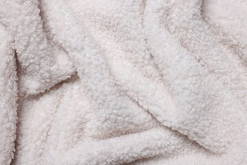 Texture of white wool fabric as background, top view