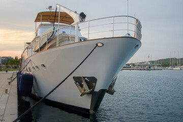 Close up of a luxury yacht bow with anchors moored at the pier  © Iv