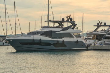 Fototapeta premium Modern luxury motor yacht with grey hull moored in marina