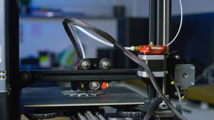 3D printer uses additive manufacturing to create a prototype in a professional workspace with automated processes and precision.