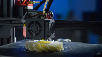 A 3D printer creates a plastic prototype using additive manufacturing in a clean workspace. This highlights automation and precision.