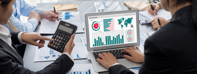 Business intelligence and data analysis concept. Analyst team working on financial data analysis dashboard on laptop screen as marketing indication for effective business strategic planning. Insight