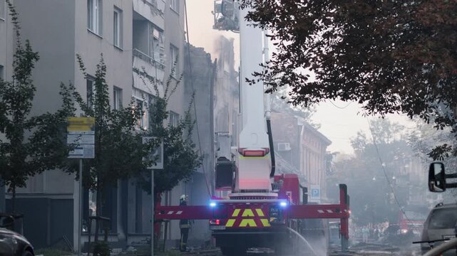 Boom crane, Fire rescue, Smoke plume. Urban firefighting operation with smoke, ladder truck, firefighters battling blaze in multi-story residential building.