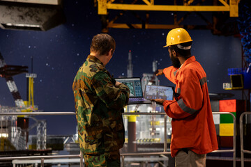 Naval soldier and african american engineer coordinating protection and logistics for offshore oil...