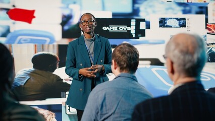 African American female speaker delivers powerful media presentation at tech conference, diverse...