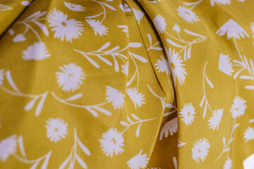 Yellow floral fabric texture with white flower print