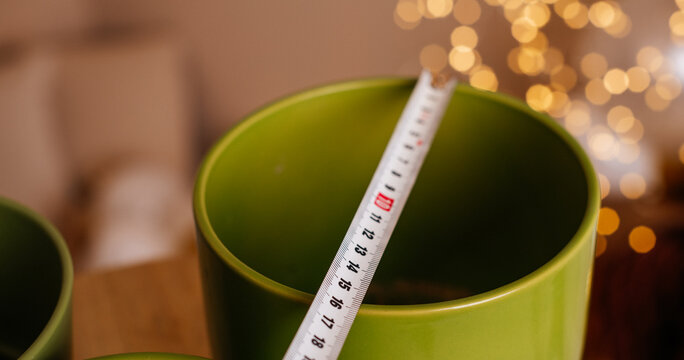 Green flower pot measured with tape
