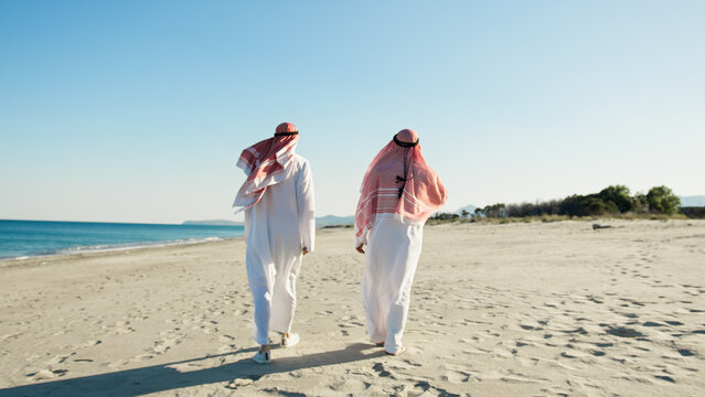 Two Sheiks Taking A Walk To Discuss About Business