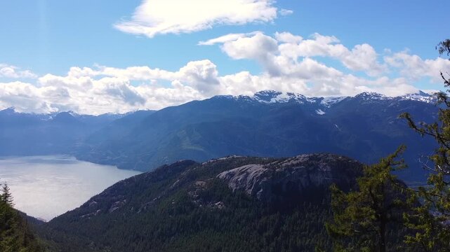 Ascending aerial drone in rugged mountain scenery behind the Stawamus Chief in Squamish British Columbia, Canada