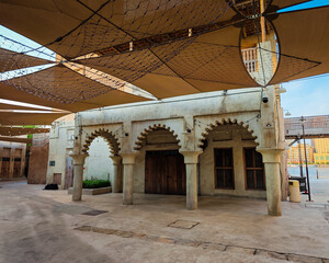 Historic buildings of traditional market in Dubai old town, authentic Arabic architecture and heritage souk atmosphere