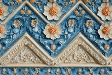 Intricate floral relief sculpture displays ornamental architectural detailing in contrasting blue and cream tones