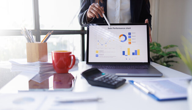 Business woman analyzing summary report data on laptop in modern office report graphics meeting at office
 - Powered by Adobe