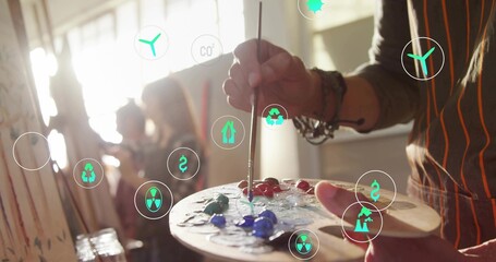 Obraz premium Painting right-side artist in striped-apron mixing on palette in art studio, eco icons, copy space