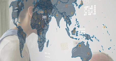 Projecting world map overlay neutral room, left woman blue top, right man pale shirt viewing icons