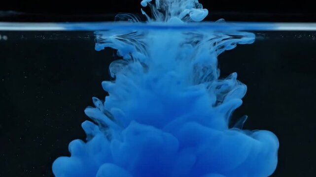 Backlit Color Explosion A dramatic shot of a colorful ink drop hitting the water and instantly exploding into a luminous, vibrant plume, strongly backlit to create a glowing, translucent effect