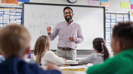 Smiling Male Teacher Explaining Lesson on Whiteboard to Students in Primary School Classroom