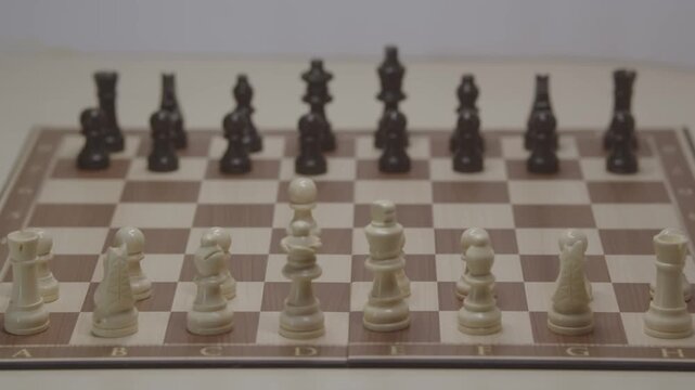 A cinematic shot of movement in a chess game. The first theoretical move is for White's pawn on d4