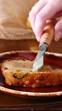 Spreading creamed honey on a slice of sourdough bread