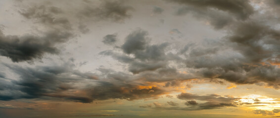 Bright colorful orange and yellow clouds on horizon. Beautiful sunset sky scenery