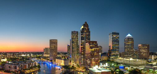 Downtown district of Tampa city in Florida, USA after sunset. Brightly illuminated high buildings in modern American urban area.