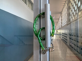 The padlock locks the glass door with a chain.