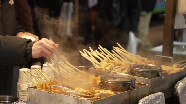 View of hot food market stall in Myeongdong Shopping Street and lights at night, Yung District, Seoul, South Korea, Asia