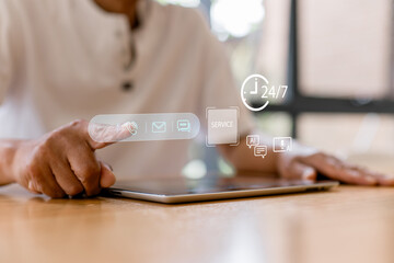 Senior man using tablet with virtual customer service icons, AI chat support and 24/7 service concept. Modern technology, digital communication, online help and smart assistance at home.