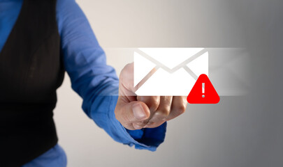 A businesswoman touching a mailing envelope with a red exclamation mark icon