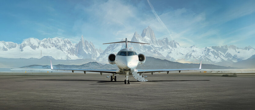private jet airplane on the ground waiting to be boarded snowy mountains in the background