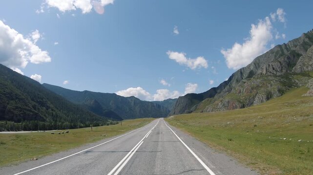 Driving in a car along the mountain road of the Chuya Highway or the Chuysky Trakt in Altai. Siberia, Russia