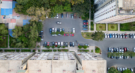 Drone shot of parking area in residential neighborhood.