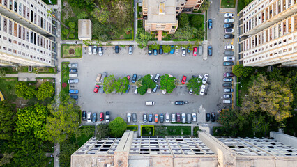 Aerial view of residential parking area with parked cars.