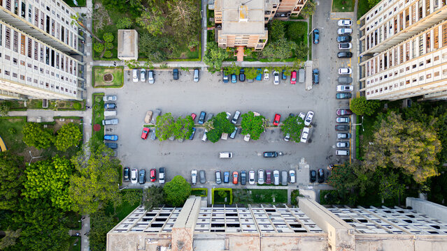 Aerial view of residential parking area with parked cars. - Powered by Adobe