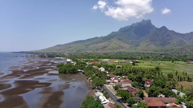 The coastline and north coast highway of East Java, passing through the Ringgit Mountains. Original 4K Aerial Drone daytime video.