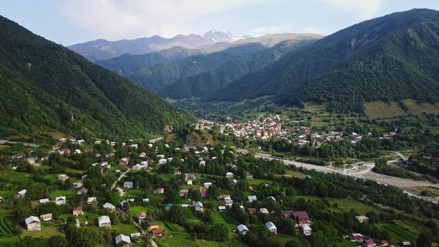 The village of Ghebi with some prominent Greater Caucasus peaks in the background. Racha-Lechkhumi, Greater Caucasus, Georgia, Caucasus, Europe