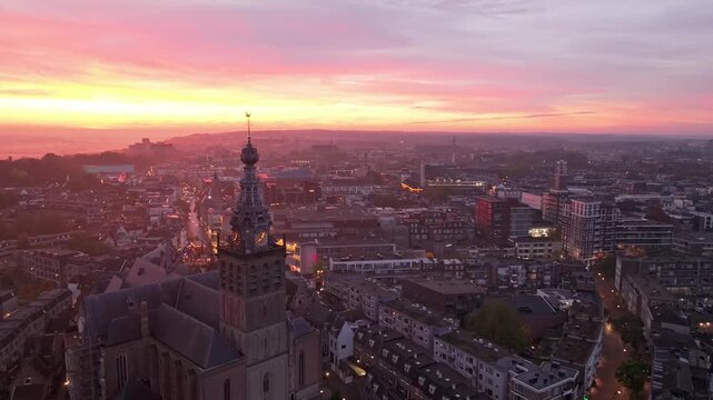 Nijmegen cityscape with Stevens Church and colorful morning sky.