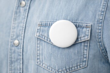 Close-Up of White Round Button on Denim Shirt Pocket in Casual Fashion Setting
