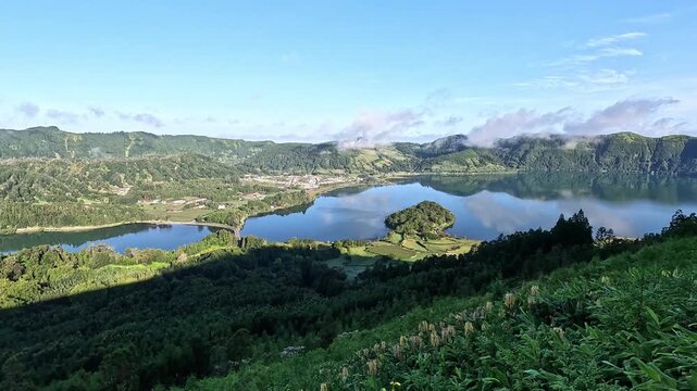 Panoramic view over Sete Cidades caldera with Lagoa Azul and Lagoa Verde, twin crater lakes within green caldera, Sao Miguel, Azores, Portugal