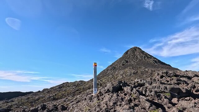 Summit cone of Mount Pico with trail marker in the foreground, Pico Island, Azores, Portugal