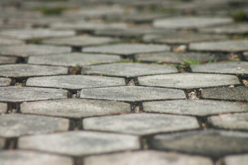 Close-up of hexagonal concrete pavers, ideal for backgrounds or urban texture.