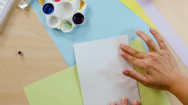 Overhead View of Artist Creating a Colorful Rorschach Inkblot Painting