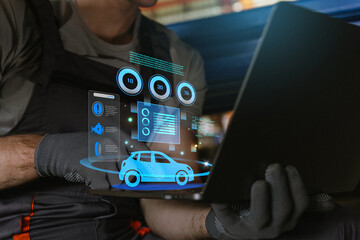 Automotive technician analyzing car using diagnostics on a laptop.