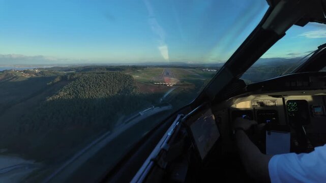 Hyperlapse of a complete approach and landing sequence on a short runway on the top of a hill next to the sea. Cockpit is bathed by sunset light. Oviedo airport, Spain (OVD).