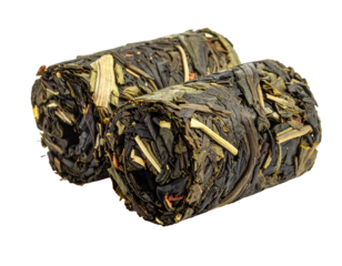 Compressed green tea leaves, bundled into two cylindrical shapes