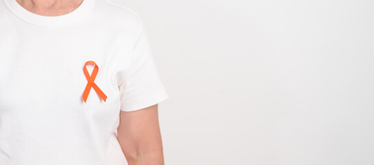 Elderly with Orange Ribbon for September Leukemia, March Kidney cancer day, Multiple Sclerosis, Self Injury Awareness month, November Complex Regional Pain Syndrome, CRPS, COPD disease concept