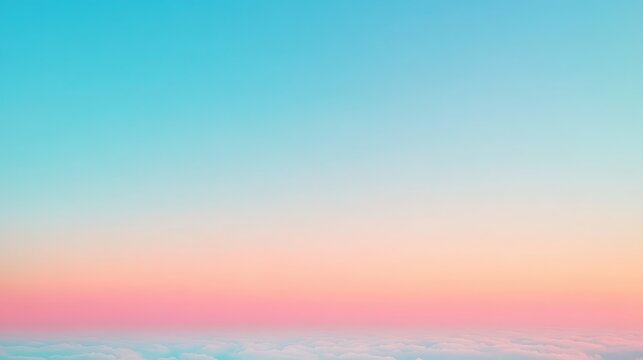 Soft gradient sky with delicate pink and peach hues blending into a clear blue expanse above a layer of white clouds at the horizon
